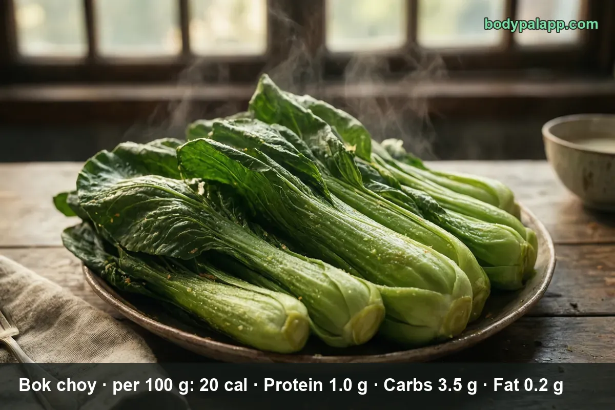 Six whole heads of fresh bok choy on a ceramic plate, steam rising from the green leaves and white stalks.