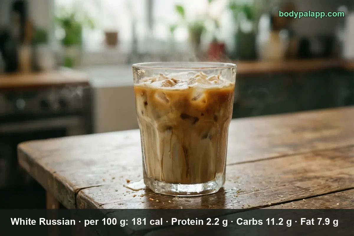 White Russian in a glass with ice, cream streaking in layers down through the dark coffee base